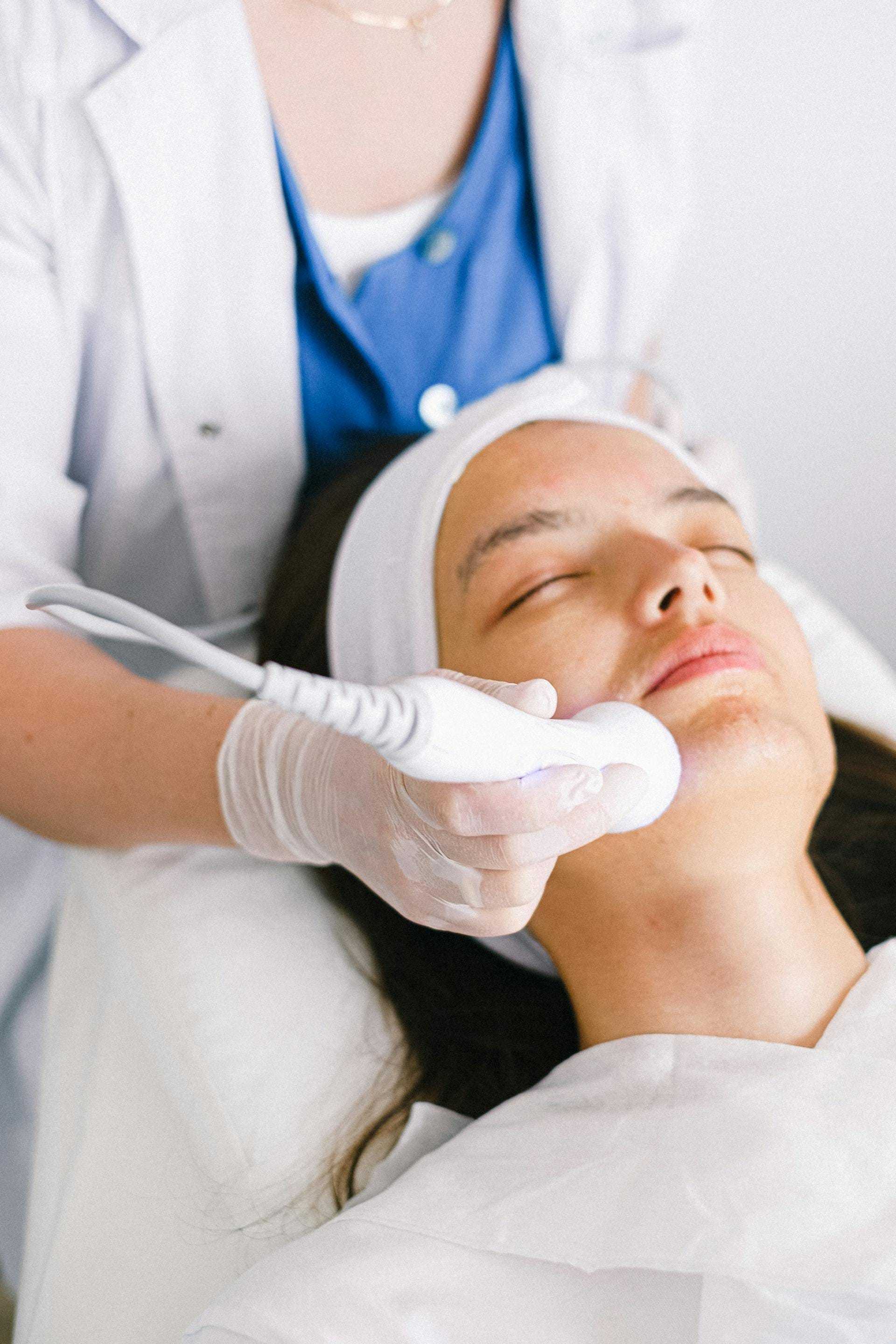 Facial treatment with a skin care device at a spa.